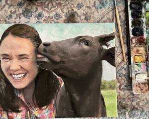 Portrait of a woman laughing with her cow by artist Maryanne Chisholm